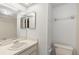 Bright bathroom featuring vanity with sink, toilet, and mirror at 2131 Ridge S Rd # 130, Largo, FL 33778