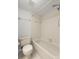 Well-lit bathroom showcasing a toilet and tiled bathtub with showerhead at 2131 Ridge S Rd # 130, Largo, FL 33778