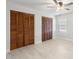 Sunlit bedroom featuring two large wooden closet and a ceiling fan, and wood flooring at 2131 Ridge S Rd # 130, Largo, FL 33778