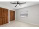 Bright bedroom with fan, wood floors, natural light, and closet at 2131 Ridge S Rd # 130, Largo, FL 33778