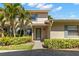 Inviting townhouse featuring a well-manicured lawn and lush tropical landscaping for enhanced curb appeal at 2131 Ridge S Rd # 130, Largo, FL 33778