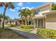 Charming townhouse with lush landscaping, sidewalk, and an inviting exterior entrance with palm trees at 2131 Ridge S Rd # 130, Largo, FL 33778