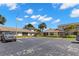 Exterior view of condos with mature trees, landscaping, and parking spaces at 2131 Ridge S Rd # 130, Largo, FL 33778