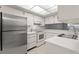 Modern kitchen with stainless steel appliances, white cabinets, and bright lighting at 2131 Ridge S Rd # 130, Largo, FL 33778