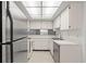 Well-lit kitchen with stainless steel appliances, white cabinetry, and ample counter space at 2131 Ridge S Rd # 130, Largo, FL 33778