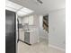 Bright kitchen with tile flooring and a stainless steel dishwasher at 2131 Ridge S Rd # 130, Largo, FL 33778