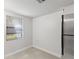 Bright eat-in kitchen featuring tile flooring, white walls, and a modern stainless steel refrigerator at 2131 Ridge S Rd # 130, Largo, FL 33778