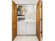 Convenient laundry area enclosed by louvered doors with washer, dryer, and water heater at 2131 Ridge S Rd # 130, Largo, FL 33778