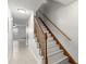 Bright stairway with wooden banister and white painted risers, leading to the upper level at 2131 Ridge S Rd # 130, Largo, FL 33778