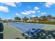 Outdoor tennis court with well-maintained surface and surrounding greenery on a sunny day at 2131 Ridge S Rd # 130, Largo, FL 33778