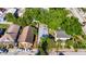 A bird's-eye view of a cozy home with a unique roof design nestled among mature trees in a quiet neighborhood at 2920 N 11Th St, Tampa, FL 33605