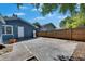 Backyard with a concrete patio, exterior house, and a wooden privacy fence at 2920 N 11Th St, Tampa, FL 33605