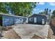 The backyard features a concrete patio, additional outbuilding, and blue siding at 2920 N 11Th St, Tampa, FL 33605
