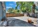 Spacious concrete patio area in fenced backyard with mature trees at 2920 N 11Th St, Tampa, FL 33605