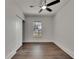 Bright bedroom featuring a ceiling fan, wood floors, and a sliding closet door at 2920 N 11Th St, Tampa, FL 33605