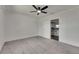 Large bedroom with closet doors, neutral carpeting and a view of the kitchen at 2920 N 11Th St, Tampa, FL 33605