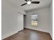 Bedroom features a ceiling fan, wood floors, and a sliding closet door at 2920 N 11Th St, Tampa, FL 33605