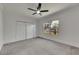 Spacious bedroom with neutral carpet, a ceiling fan and a window view to the backyard at 2920 N 11Th St, Tampa, FL 33605