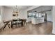 Open dining room area features modern light fixture and breakfast bar into the kitchen at 2920 N 11Th St, Tampa, FL 33605
