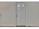 Interior view of the 4-panel white door with a glass top and white trim at 2920 N 11Th St, Tampa, FL 33605