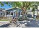 Charming bungalow-style home with blue siding, a red front door, and a covered carport at 2920 N 11Th St, Tampa, FL 33605