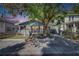 A charming blue bungalow with a covered carport and a brick walkway up to the front door at 2920 N 11Th St, Tampa, FL 33605