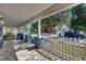 Spacious porch with patterned tile flooring, white railing, and sturdy columns at 2920 N 11Th St, Tampa, FL 33605
