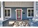 A close-up of the front door with sidelight windows and beautiful tile on the front porch at 2920 N 11Th St, Tampa, FL 33605