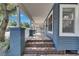 Inviting front porch featuring unique tilework, sturdy pillars, and a white picket fence at 2920 N 11Th St, Tampa, FL 33605