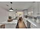 Open kitchen layout with an island cooktop, stainless appliances and view to dining area at 2920 N 11Th St, Tampa, FL 33605