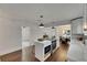 Kitchen island with stainless appliances and eat-in seating and view to the dining room at 2920 N 11Th St, Tampa, FL 33605