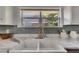 Close up of kitchen sink, gray backsplash, granite countertops, and stainless appliances at 2920 N 11Th St, Tampa, FL 33605