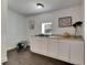 Well-lit kitchenette featuring sleek white cabinetry, a sink, and countertop space at 2920 N 11Th St, Tampa, FL 33605