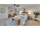 Beautiful main bedroom with a queen-sized bed, ceiling fan, a rug, and a seating area at 2920 N 11Th St, Tampa, FL 33605