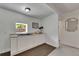 A wet bar is equipped with white cabinets, a dark sink and a stylish counter at 2920 N 11Th St, Tampa, FL 33605