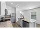 Well-lit kitchen with stainless steel refrigerator and granite countertops and modern faucet at 29498 Fedora Cir, Brooksville, FL 34602