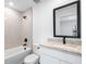 Bathroom with a shower over bath, a granite countertop vanity and black fixtures at 29535 Fedora Cir, Brooksville, FL 34602