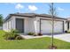 Charming single-story home featuring a well-manicured lawn, neutral paint, and an attached two-car garage at 29587 Fedora Cir, Brooksville, FL 34602