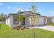 Charming single-story home featuring a two-car garage, modern landscaping, and a welcoming entrance at 29629 Fedora Cir, Brooksville, FL 34602