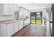 Bright kitchen featuring granite countertops, stainless steel appliances, and a view of the backyard at 29629 Fedora Cir, Brooksville, FL 34602