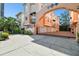 Gated community with peach-colored townhomes and lush landscaping at 3025 W Grovewood Ct # B, Tampa, FL 33629