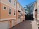 Peach-colored townhomes with attached garages and balconies at 3025 W Grovewood Ct # B, Tampa, FL 33629