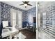 Stylish home office with bold wallpaper, plantation shutters, and functional workspace at 3025 W Grovewood Ct # B, Tampa, FL 33629