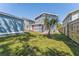 Backyard featuring a palm tree and views of the two-story blue house at 307 S Newport Ave, Tampa, FL 33606