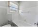 Bathroom features white tiled walls around the tub and a window with blinds at 307 S Newport Ave, Tampa, FL 33606