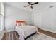 Bedroom featuring a ceiling fan, a cozy bed with stylish bedding, and ample natural light at 307 S Newport Ave, Tampa, FL 33606