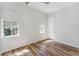 White bedroom offers two windows for natural light, paired with sleek, modern floors at 307 S Newport Ave, Tampa, FL 33606