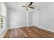 Bedroom with wood floors, ceiling fan, natural light from two windows and a door to the hall at 307 S Newport Ave, Tampa, FL 33606
