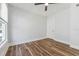 Bright bedroom featuring a ceiling fan, wood-look floors, and fresh, neutral paint at 307 S Newport Ave, Tampa, FL 33606