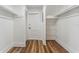 Spacious walk-in closet featuring wooden floors, white walls, and shelving for storage at 307 S Newport Ave, Tampa, FL 33606